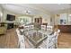 Open-concept living and dining area with fireplace, television, and hardwood floors at 1004 Fairbanks Ct, Indian Trail, NC 28079