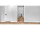 Hallway featuring light walls and wood flooring leading into open rooms at 101 Churchill Dr, Kings Mountain, NC 28086