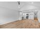 Open-concept kitchen featuring white cabinetry, stainless steel appliances, and wood flooring at 101 Churchill Dr, Kings Mountain, NC 28086