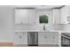 Bright kitchen featuring stainless steel dishwasher and faucet with white cabinets and subway tile at 101 Churchill Dr, Kings Mountain, NC 28086