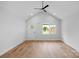 Bright living room features wood flooring, a modern ceiling fan, and a large window overlooking the front yard at 101 Churchill Dr, Kings Mountain, NC 28086