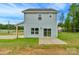 Home's backyard features a patio, sliding glass doors, and ample space for outdoor activities at 103 Churchill Dr, Kings Mountain, NC 28086