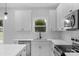 Bright kitchen featuring modern white cabinets, sleek countertops, and contemporary stainless steel appliances at 103 Churchill Dr, Kings Mountain, NC 28086