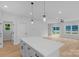 Open-concept kitchen with a central island, modern pendant lights, and a view into the spacious living area at 103 Churchill Dr, Kings Mountain, NC 28086