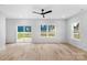 Large living room with wood-look floors, bright windows, and a ceiling fan at 103 Churchill Dr, Kings Mountain, NC 28086