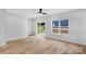 Spacious living room features wood-look floors, a ceiling fan, and sliding glass doors to the backyard at 103 Churchill Dr, Kings Mountain, NC 28086