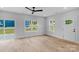 Bright, open living room with wood-look floors, a ceiling fan, and ample natural light at 103 Churchill Dr, Kings Mountain, NC 28086