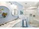 Bathroom featuring double sinks, sleek marble countertops and a glass-enclosed shower at 106 Phifer St, Fort Mill, SC 29715