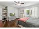 Comfortable bedroom featuring hardwood floors, a ceiling fan, natural light, and built-in shelving for storage at 106 Phifer St, Fort Mill, SC 29715