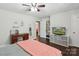 Cozy bedroom featuring hardwood floors, natural light, neutral paint, a desk, and storage shelves at 106 Phifer St, Fort Mill, SC 29715