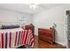 Inviting bedroom featuring hardwood floors, two windows, and a light color palette; complete with dresser and lamps at 106 Phifer St, Fort Mill, SC 29715