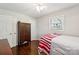 Cozy bedroom featuring hardwood floors, a ceiling fan, closet, neutral walls, and natural light from the window at 106 Phifer St, Fort Mill, SC 29715