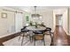 Elegant dining area with a wooden table, modern chairs, chandelier, and a barn door feature at 106 Phifer St, Fort Mill, SC 29715