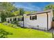 Charming white brick home with black shutters, landscaped yard, and inviting curb appeal at 106 Phifer St, Fort Mill, SC 29715