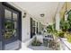 Inviting front porch with rocking chairs, stylish accents, and a beautiful entry door at 106 Phifer St, Fort Mill, SC 29715