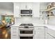 Well-equipped kitchen with stainless steel appliances, white cabinets, and open shelving for a modern and stylish design at 106 Phifer St, Fort Mill, SC 29715