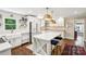 Bright kitchen featuring an island with seating, stylish lighting, white cabinets, and modern stainless steel appliances at 106 Phifer St, Fort Mill, SC 29715