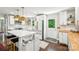 Bright kitchen featuring an island with seating, stylish lighting, white cabinets, and modern stainless steel appliances at 106 Phifer St, Fort Mill, SC 29715
