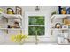 Bright kitchen sink area with window view and decorative shelving at 106 Phifer St, Fort Mill, SC 29715