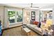 Bright living room featuring a comfortable sofa, jute rug, and a large window offering a scenic view at 106 Phifer St, Fort Mill, SC 29715