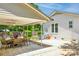 Covered patio with ceiling fans, dining table, and a seating area, perfect for outdoor gatherings at 106 Phifer St, Fort Mill, SC 29715