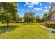Expansive backyard featuring lush lawn, mature trees, and screened porch; perfect for outdoor relaxation at 1070 Blueberry Rd, Salisbury, NC 28147