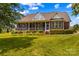 Spacious backyard with a screened porch, lush green grass, and mature landscaping at 1070 Blueberry Rd, Salisbury, NC 28147