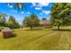 Well-maintained lawn with mature trees surrounds the house and screened in porch at 1070 Blueberry Rd, Salisbury, NC 28147