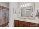Well-lit bathroom with white framed mirror, brown vanity, and neutral countertop provides a clean and inviting space at 1070 Blueberry Rd, Salisbury, NC 28147