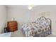 Bright bedroom with a metal-framed bed, floral comforter, and wooden dresser creates a cozy and inviting atmosphere at 1070 Blueberry Rd, Salisbury, NC 28147
