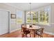 Bright dining area with large windows offering scenic views of the outdoors, with hardwood floors at 1070 Blueberry Rd, Salisbury, NC 28147