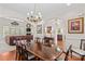 Open-concept dining room featuring hardwood floors, a large chandelier, and living room views at 1070 Blueberry Rd, Salisbury, NC 28147