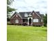 Charming brick home featuring a well-manicured lawn and welcoming front porch at 1070 Blueberry Rd, Salisbury, NC 28147