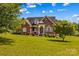 Inviting two-story brick home with beautiful landscaping and a well-maintained lawn creates instant curb appeal at 1070 Blueberry Rd, Salisbury, NC 28147
