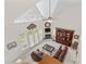 Bright living room boasts a fireplace, high ceiling, large windows, and leather couches for a cozy, inviting atmosphere at 1070 Blueberry Rd, Salisbury, NC 28147