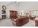 Open living room featuring vaulted ceiling, fireplace, and built-in bookcase with elegant archway to dining area at 1070 Blueberry Rd, Salisbury, NC 28147