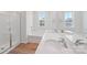 Bright bathroom featuring double sinks, soaking tub, and shower at 11131 Cardinal Creek Ave, Charlotte, NC 28215