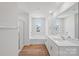 Modern bathroom featuring double vanity, soaking tub, and a glass-enclosed shower at 11131 Cardinal Creek Ave, Charlotte, NC 28215