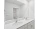 Bathroom featuring a large mirror above dual sinks with white cabinets and countertops at 11131 Cardinal Creek Ave, Charlotte, NC 28215