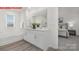 Bright bathroom with double vanity, tub, wood-look floors and natural light at 11131 Cardinal Creek Ave, Charlotte, NC 28215