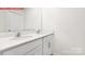 Bathroom featuring a double vanity with modern faucets, white cabinetry, and a large mirror at 11131 Cardinal Creek Ave, Charlotte, NC 28215