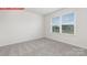 Bright bedroom featuring a neutral color palette, plush carpeting, and a large window with neighborhood views at 11131 Cardinal Creek Ave, Charlotte, NC 28215