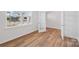 Bedroom with wood floors, white trim, and a window overlooking a construction site at 11131 Cardinal Creek Ave, Charlotte, NC 28215