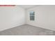 This bedroom features carpeted floors, and natural light from the window at 11131 Cardinal Creek Ave, Charlotte, NC 28215