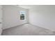 Bedroom featuring a window and neutral carpet with a view of the outdoors at 11131 Cardinal Creek Ave, Charlotte, NC 28215
