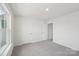 This is a bedroom with neutral carpet, white walls and trim, a large window and white doors at 11131 Cardinal Creek Ave, Charlotte, NC 28215
