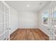 Bright bedroom with wood floors, French doors, and a large window letting in natural light at 11131 Cardinal Creek Ave, Charlotte, NC 28215