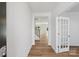 Entryway with wood floors leading to staircase, living area and a glass door to the side at 11131 Cardinal Creek Ave, Charlotte, NC 28215