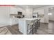 Bright kitchen featuring white cabinets, stainless steel appliances, and a spacious center island with bar stools at 11131 Cardinal Creek Ave, Charlotte, NC 28215