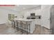 Modern kitchen boasts white cabinetry, stainless steel appliances, and a center island with seating at 11131 Cardinal Creek Ave, Charlotte, NC 28215